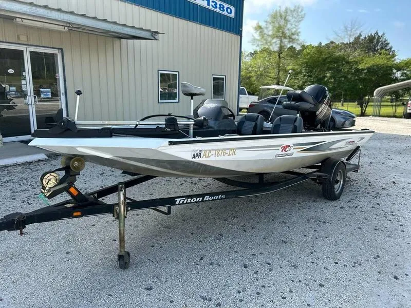 Slide: The Image of 2007 Triton TC-17 boat on trailer, parked outside a building. - 3