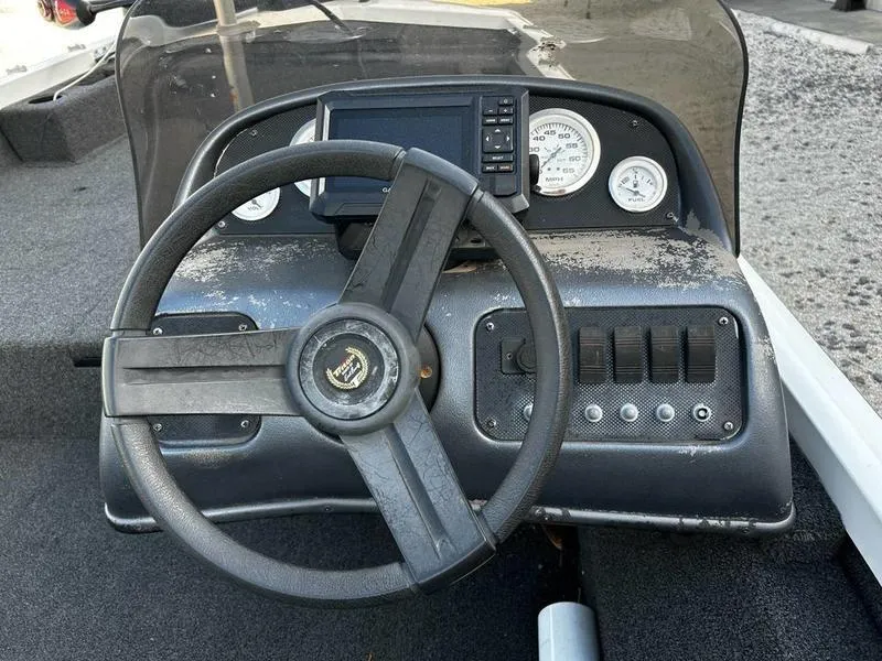 Slide: The Image of Steering console of a 2007 Triton TC-17 boat with gauges and controls. - 6