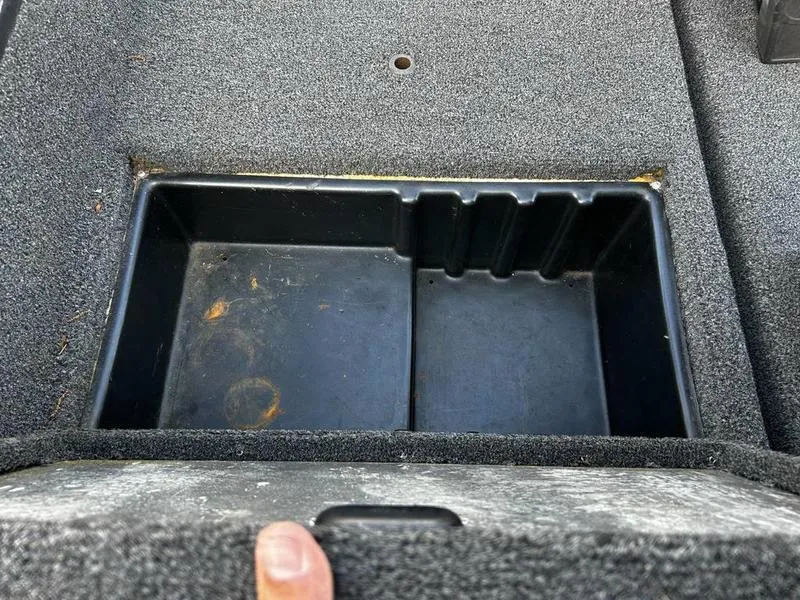 Slide: The Image of Empty storage compartment in a 2007 Triton TC-17 boat, featuring a textured interior. - 9