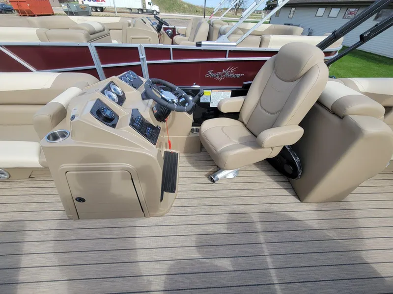 Slide: The Image of 2023 SunChaser Geneva Cruise 24 LR DH boat interior with captain's chair and control panel. - 10