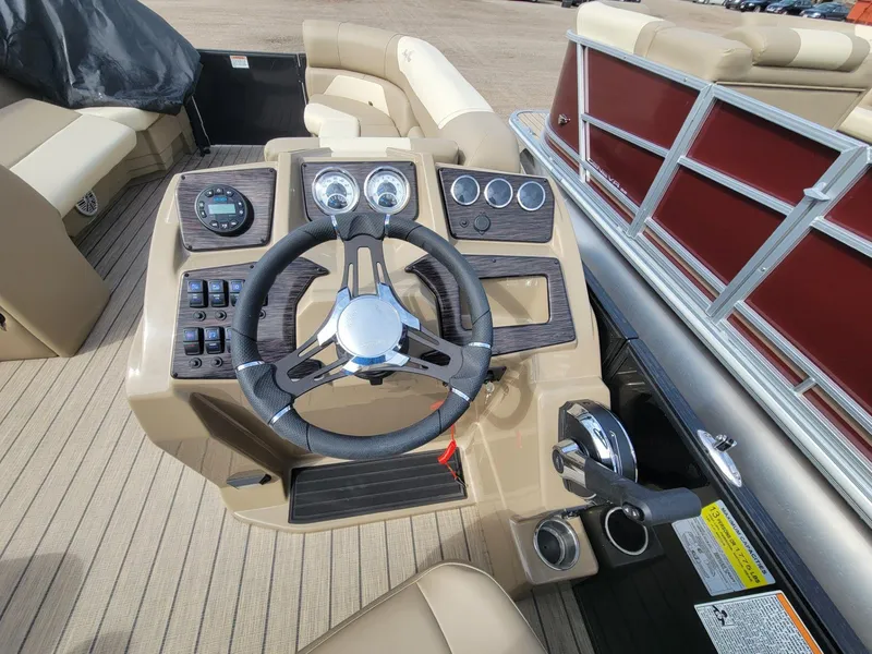 Slide: The Image of 2023 SunChaser Geneva Cruise 24 LR DH boat dashboard with steering wheel and controls. - 11