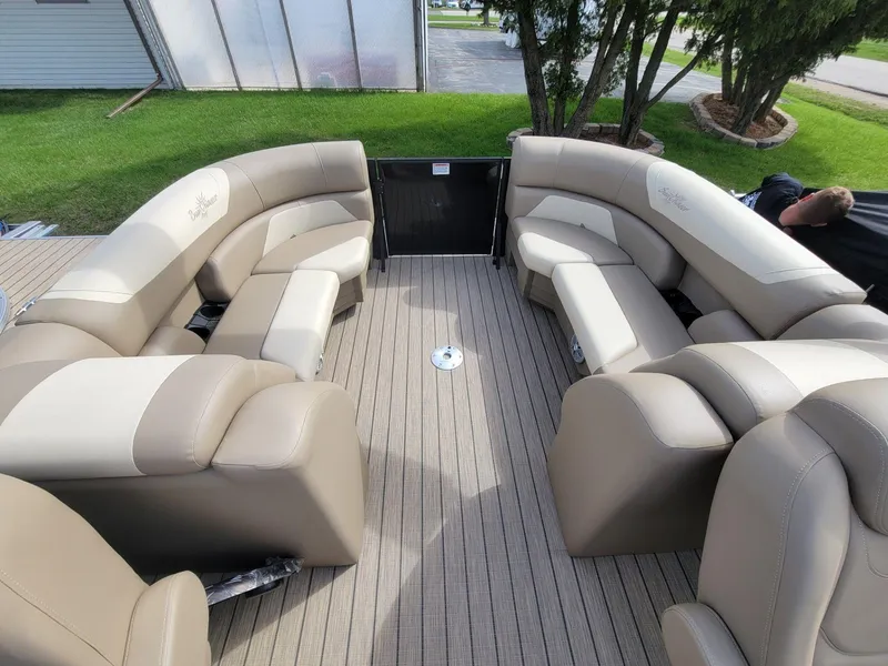 Slide: The Image of 2023 SunChaser Geneva Cruise 24 LR DH pontoon boat with beige seating and spacious deck. - 12