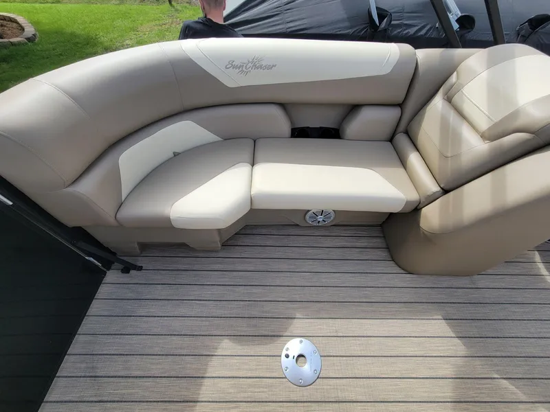 Slide: The Image of 2023 SunChaser Geneva Cruise 24 LR DH boat interior with beige seating and striped flooring. - 14