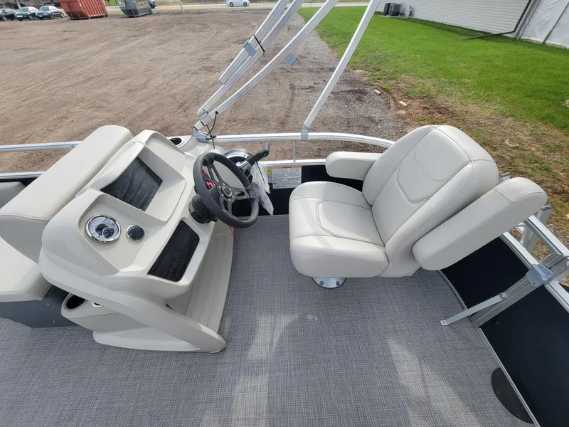 Slide: The Image of 2023 SunChaser Vista 16 Fish boat interior with steering console and comfortable seating. - 14
