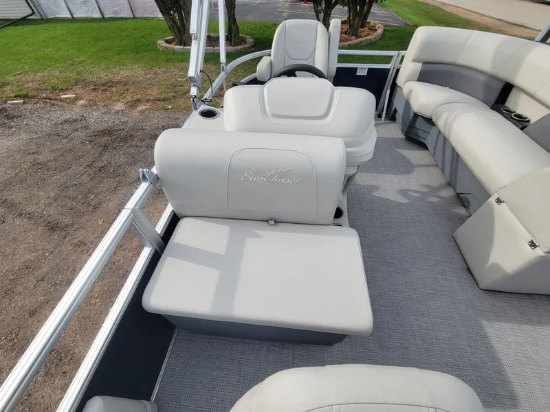 Slide: The Image of 2023 SunChaser Vista 16 Fish pontoon boat interior with plush seating and steering console. - 15
