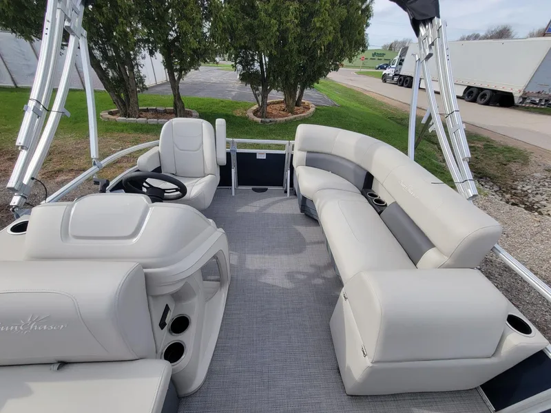 Slide: The Image of 2023 SunChaser Vista 16 Fish pontoon boat interior with plush seating and steering console. - 17