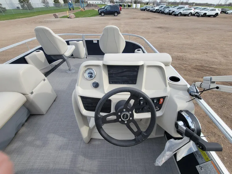 Slide: The Image of 2023 SunChaser Vista 16 Fish boat interior with steering wheel and seating. - 18