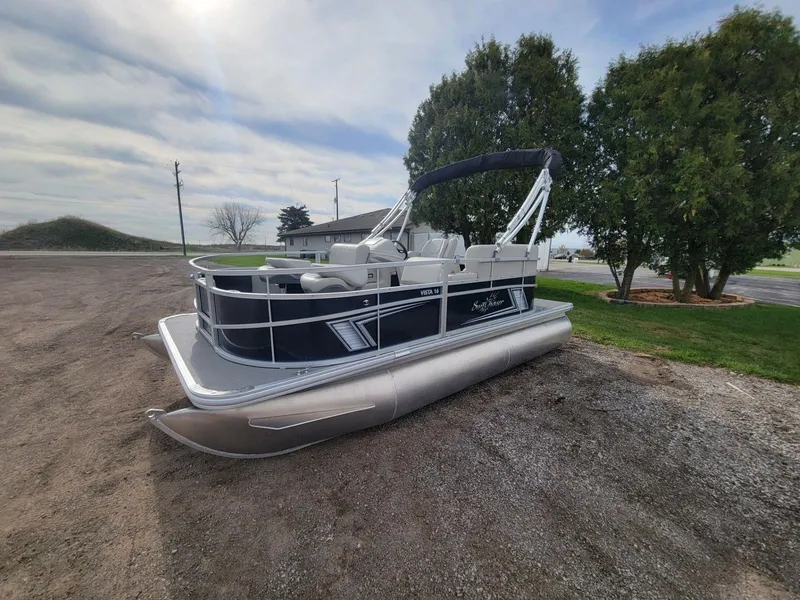 Slide: The Image of 2023 SunChaser Vista 16 Fish pontoon boat parked on gravel near trees. - 4