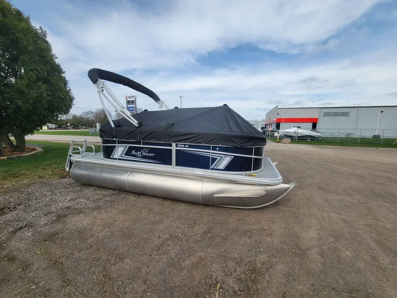 Slide: The Image of 2023 SunChaser Vista 16 Fish pontoon boat with cover, parked outdoors. - 6