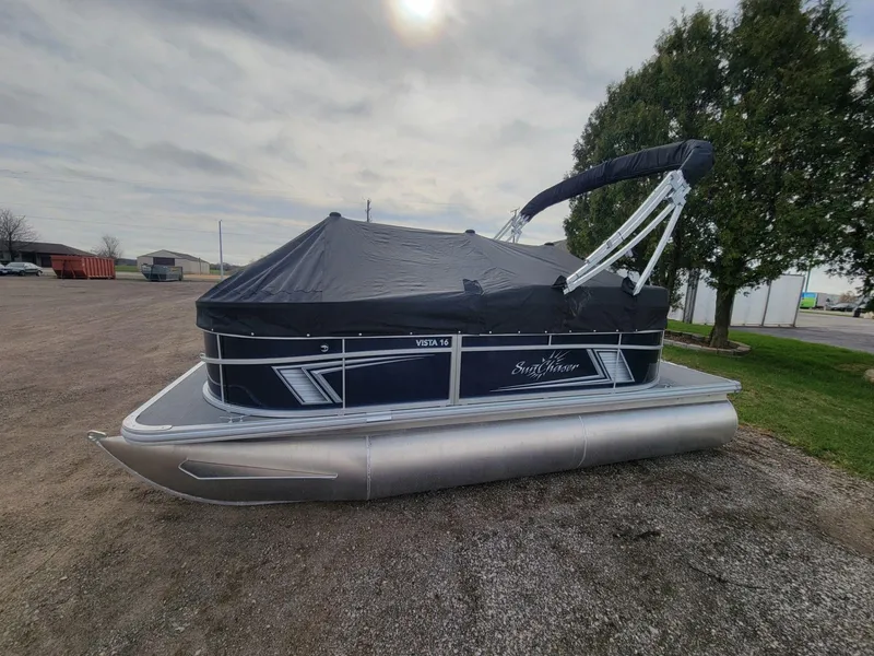 Slide: The Image of 2023 SunChaser Vista 16 Fish pontoon boat with cover, parked outdoors. - 8