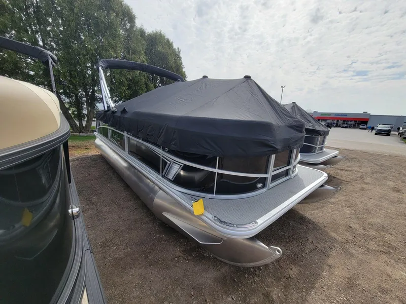 Slide: The Image of 2024 SunChaser Vista 20 CRB pontoon boat with cover, parked outdoors. - 3