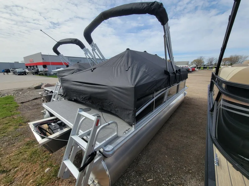 Slide: The Image of 2024 SunChaser Vista 20 CRB pontoon boat with cover, parked outdoors. - 5