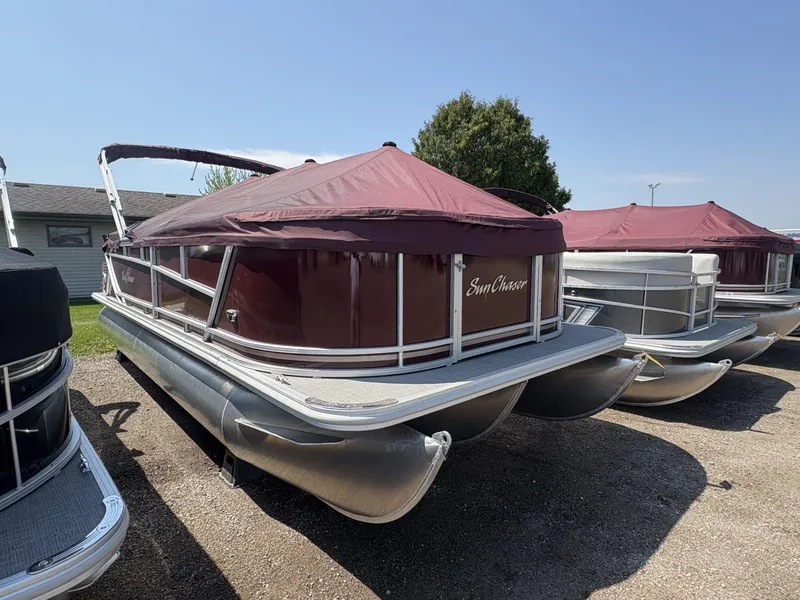 Slide: The Image of 2023 SunChaser Geneva Cruise 22 LR DH pontoon boat with maroon cover, parked outdoors. - 3