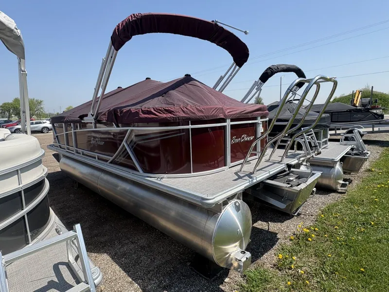 Slide: The Image of 2023 SunChaser Geneva Cruise 22 LR DH pontoon boat with maroon canopy, parked outdoors. - 5