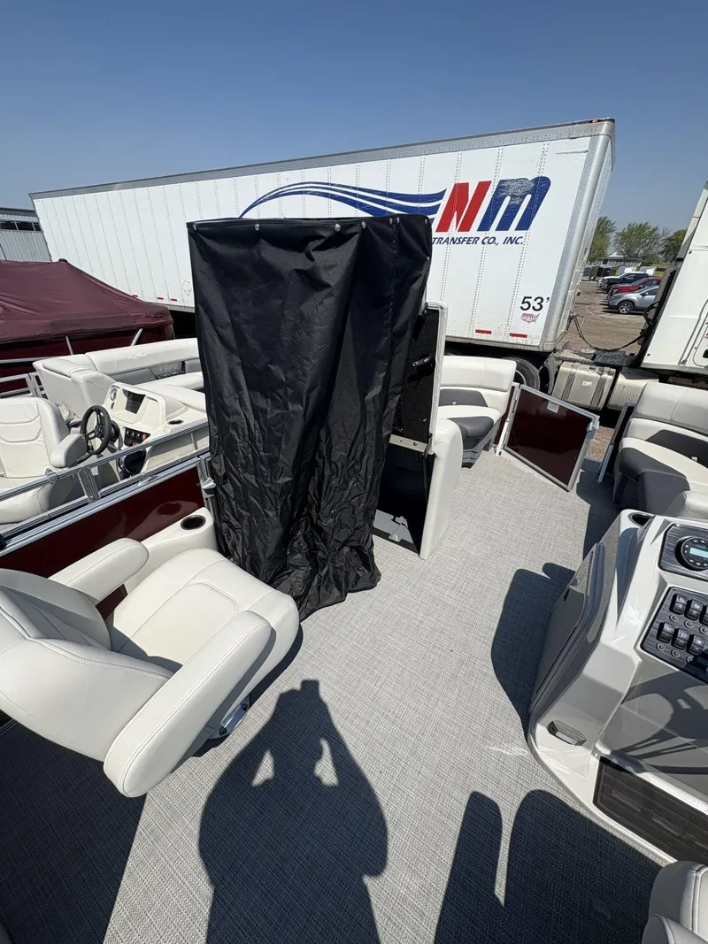 Slide: The Image of 2023 SunChaser Geneva Cruise 22 LR DH pontoon boat with white seating and black privacy curtain. - 7