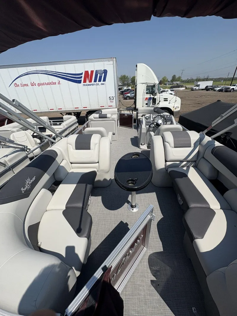 Slide: The Image of 2023 SunChaser Geneva Cruise 22 LR DH pontoon boat interior with luxurious seating and table. - 8