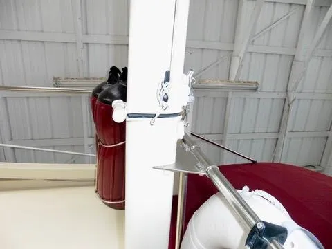 Slide: The Image of 2001 Camano Trawler boat interior with red and white details, featuring a metal pole and equipment. - 12