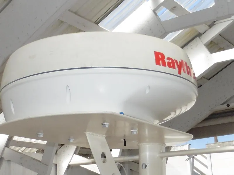 Slide: The Image of Raytheon radar on 2001 Camano Trawler, mounted under a metal structure. - 13