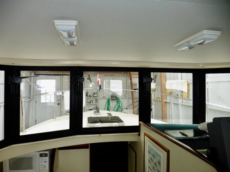 Slide: The Image of 2001 Camano Trawler interior with large windows and nautical decor. - 18