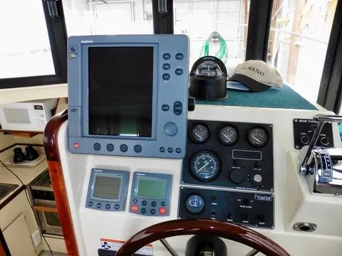 Slide: The Image of 2001 Camano Trawler helm with navigation equipment and controls. - 21