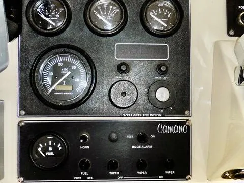 Slide: The Image of Control panel of a 2001 Camano Trawler with gauges and switches. - 22