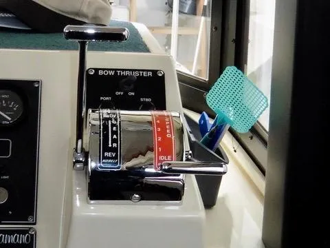 Slide: The Image of 2001 Camano Trawler control panel with throttle lever and bow thruster switch. - 24