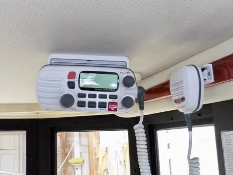 Slide: The Image of 2001 Camano Trawler interior with mounted marine radio and microphone. - 25