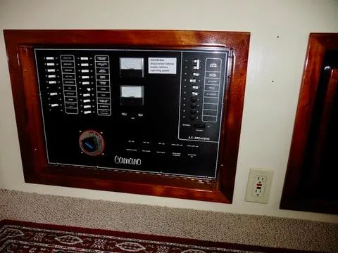 Slide: The Image of Electrical panel of a 2001 Camano Trawler boat, featuring switches and meters. - 30