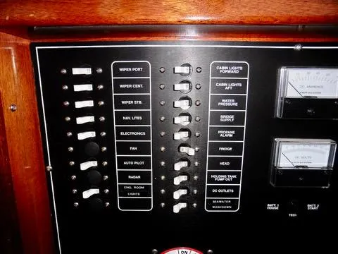 Slide: The Image of Control panel of a 2001 Camano Trawler with labeled switches and gauges. - 31