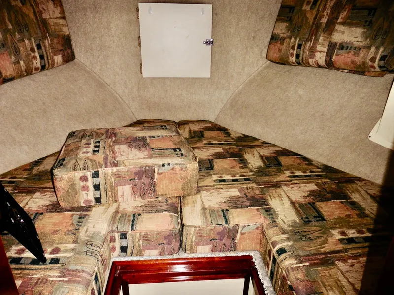 Slide: The Image of 2001 Camano Trawler interior cabin with patterned cushions and compact design. - 36