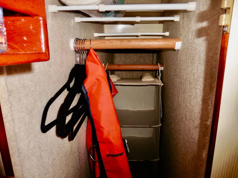 Slide: The Image of Small closet in a 2001 Camano Trawler with hangers and storage. - 39