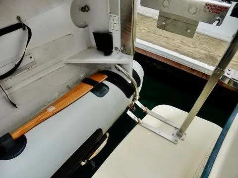 Slide: The Image of 2001 Camano Trawler boat interior with secured equipment and wooden oar. - 43