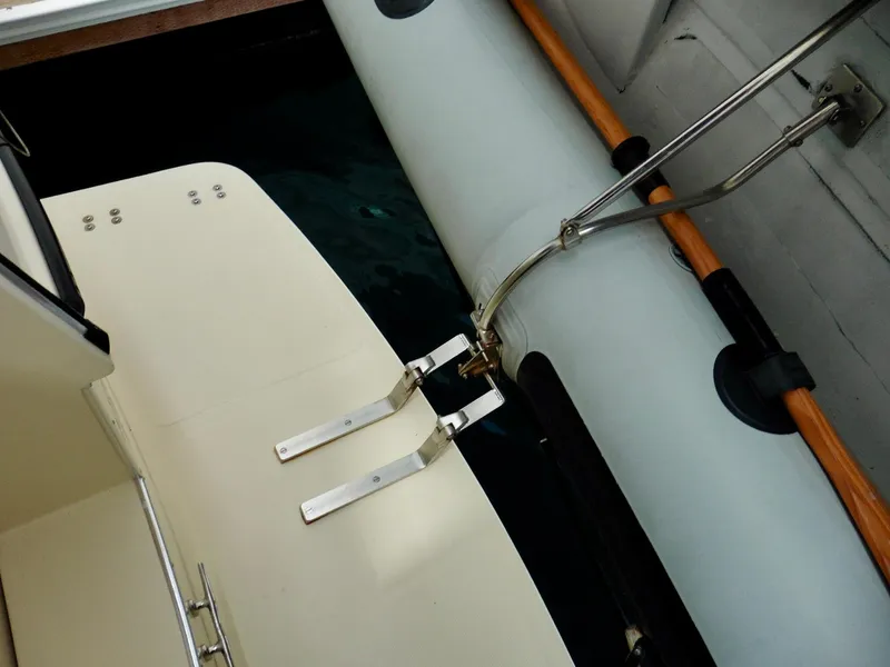 Slide: The Image of 2001 Camano Trawler boat deck with metal fittings and inflatable side attachment. - 44