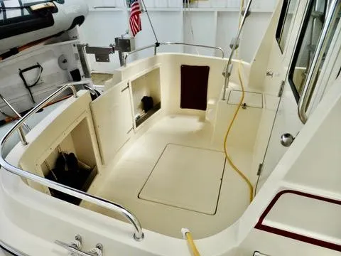 Slide: The Image of 2001 Camano Trawler boat deck with storage compartments and railing. - 48