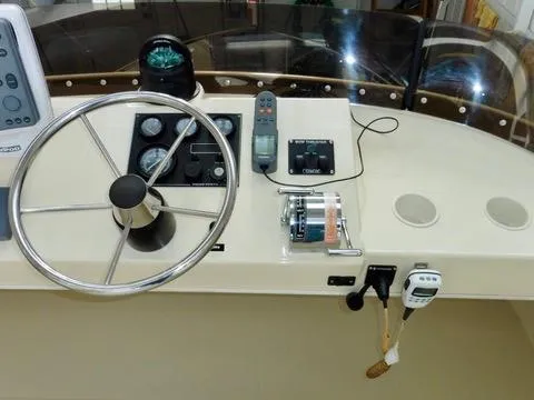 Slide: The Image of 2001 Camano Trawler helm with steering wheel, gauges, and navigation equipment. - 6