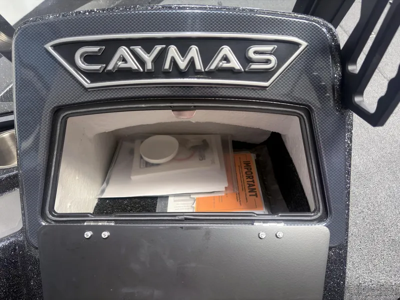 Slide: The Image of 2025 Caymas DV 22 storage compartment with documents and manuals inside. - 10