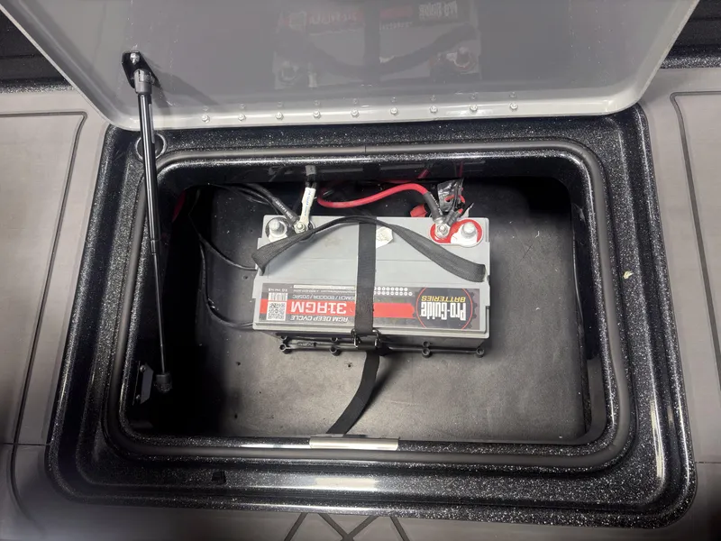 Slide: The Image of Battery compartment of 2025 Caymas DV 22 boat, featuring a Pro-Guide battery. - 11
