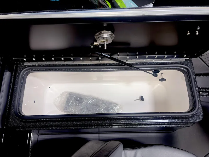Slide: The Image of Open storage compartment in 2025 Caymas DV 22 boat, featuring sleek design and secure latch. - 12