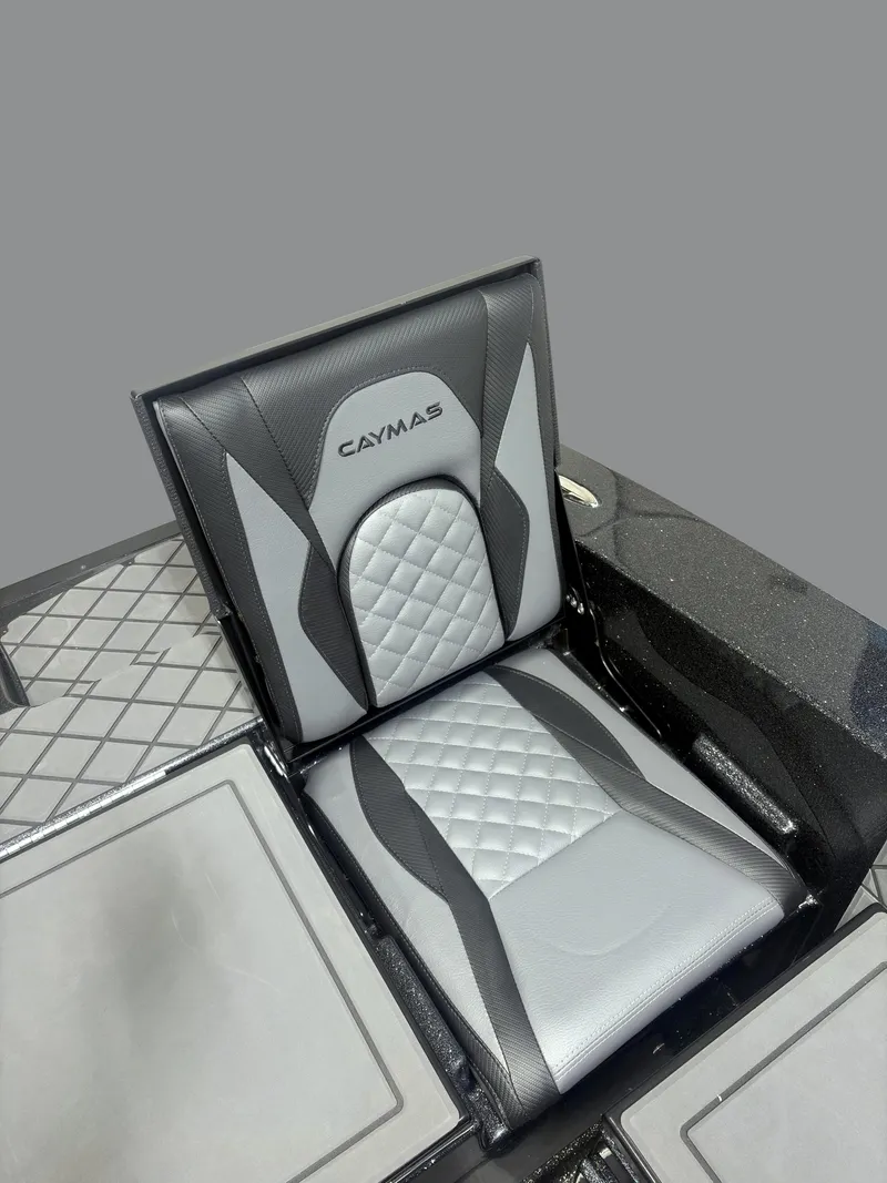 Slide: The Image of 2025 Caymas DV 22 boat seat with sleek black and gray design. - 15
