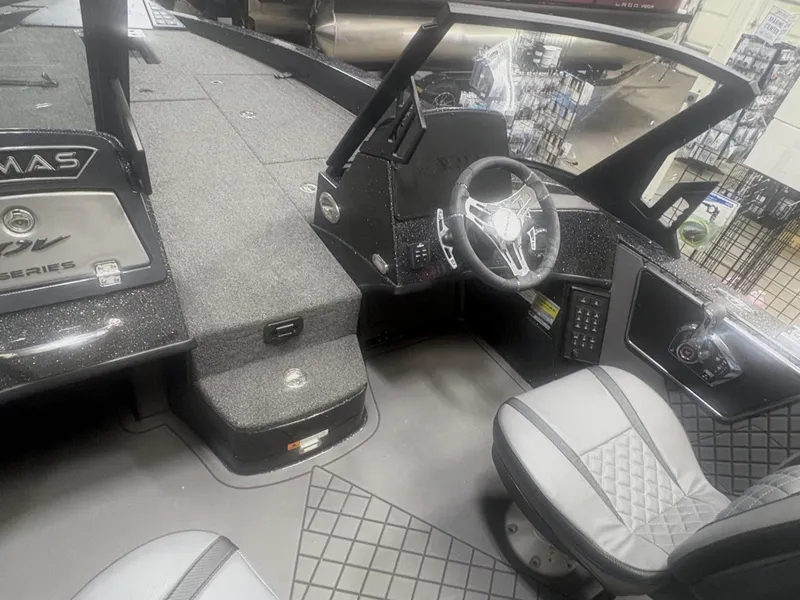 Slide: The Image of 2025 Caymas DV 22 boat interior with steering wheel and seating, showcasing modern design. - 4