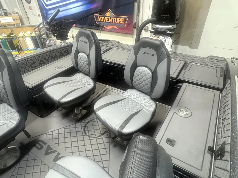 Slide: The Image of 2025 Caymas DV 22 boat interior with gray seating and adventure-themed decor. - 5