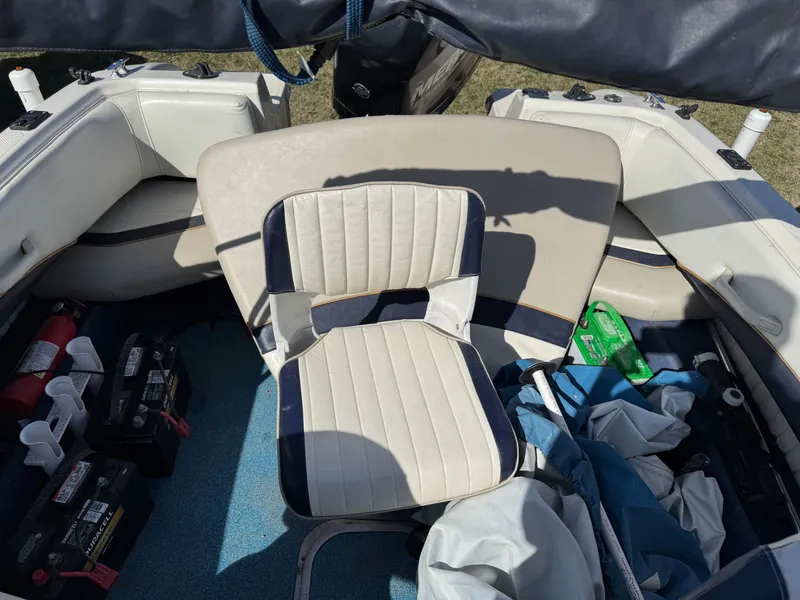 Slide: The Image of Interior of a 1996 Bayliner 1704 SF boat with seating and equipment. - 10