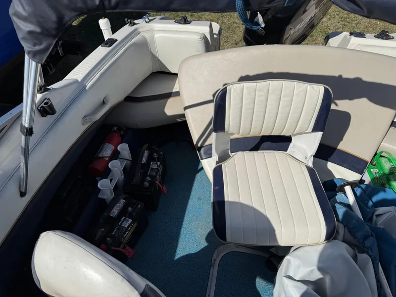 Slide: The Image of 1996 Bayliner 1704 SF boat interior with seating and equipment storage. - 11