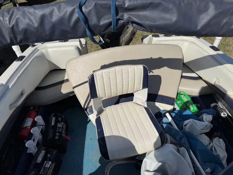 Slide: The Image of 1996 Bayliner 1704 SF boat interior with seating and equipment storage. - 12