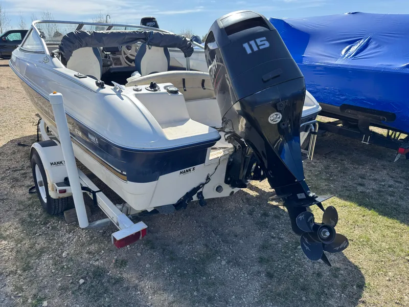 Slide: The Image of 1996 Bayliner 1704 SF boat with 115 HP outboard motor on a trailer. - 5