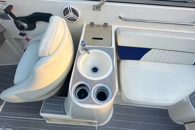 Slide: The Image of 2006 Rinker 262 Captiva Bowrider interior with seating, cup holders, and speaker. - 10
