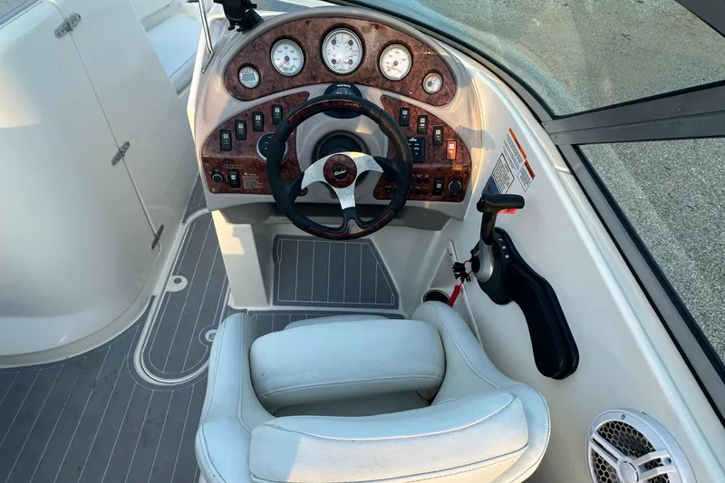 Slide: The Image of 2006 Rinker 262 Captiva Bowrider dashboard with steering wheel and gauges. - 11