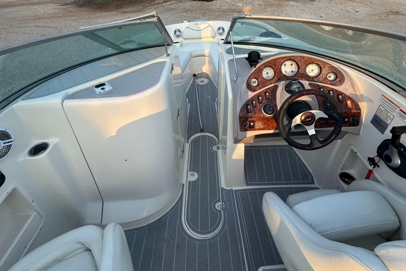 Slide: The Image of 2006 Rinker 262 Captiva Bowrider interior with sleek dashboard and comfortable seating. - 16