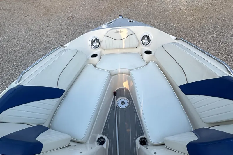 Slide: The Image of 2006 Rinker 262 Captiva Bowrider boat interior with white and blue seating. - 17