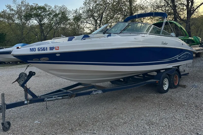 Slide: The Image of 2006 Rinker 262 Captiva Bowrider on trailer, parked outdoors. - 2